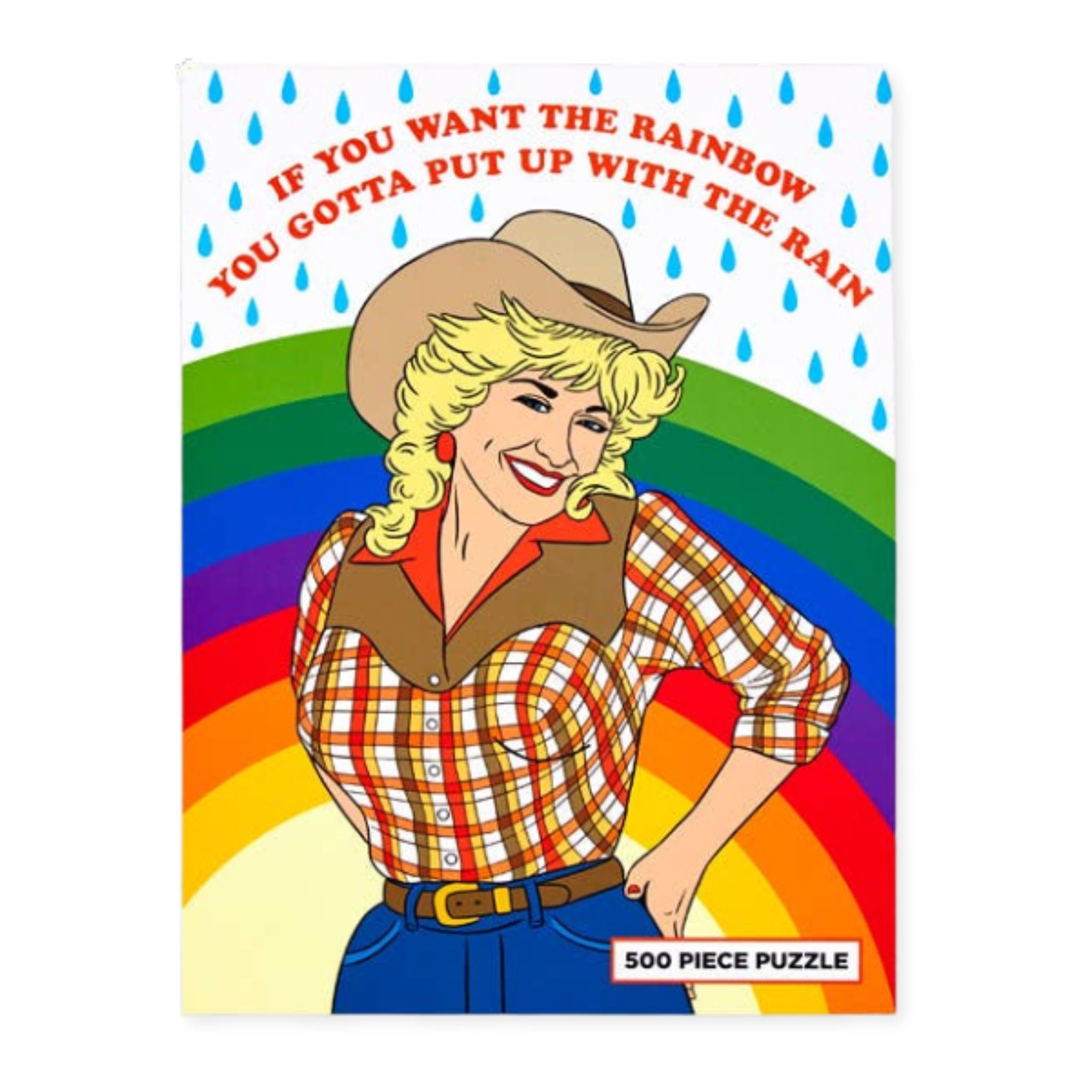 A 500-piece puzzle featuring a retro-style cowboy woman with the text 'IF YOU WANT THE RAINBOW YOU GOTTA PUT UP WITH THE RAIN' on a white background with blue raindrops.
