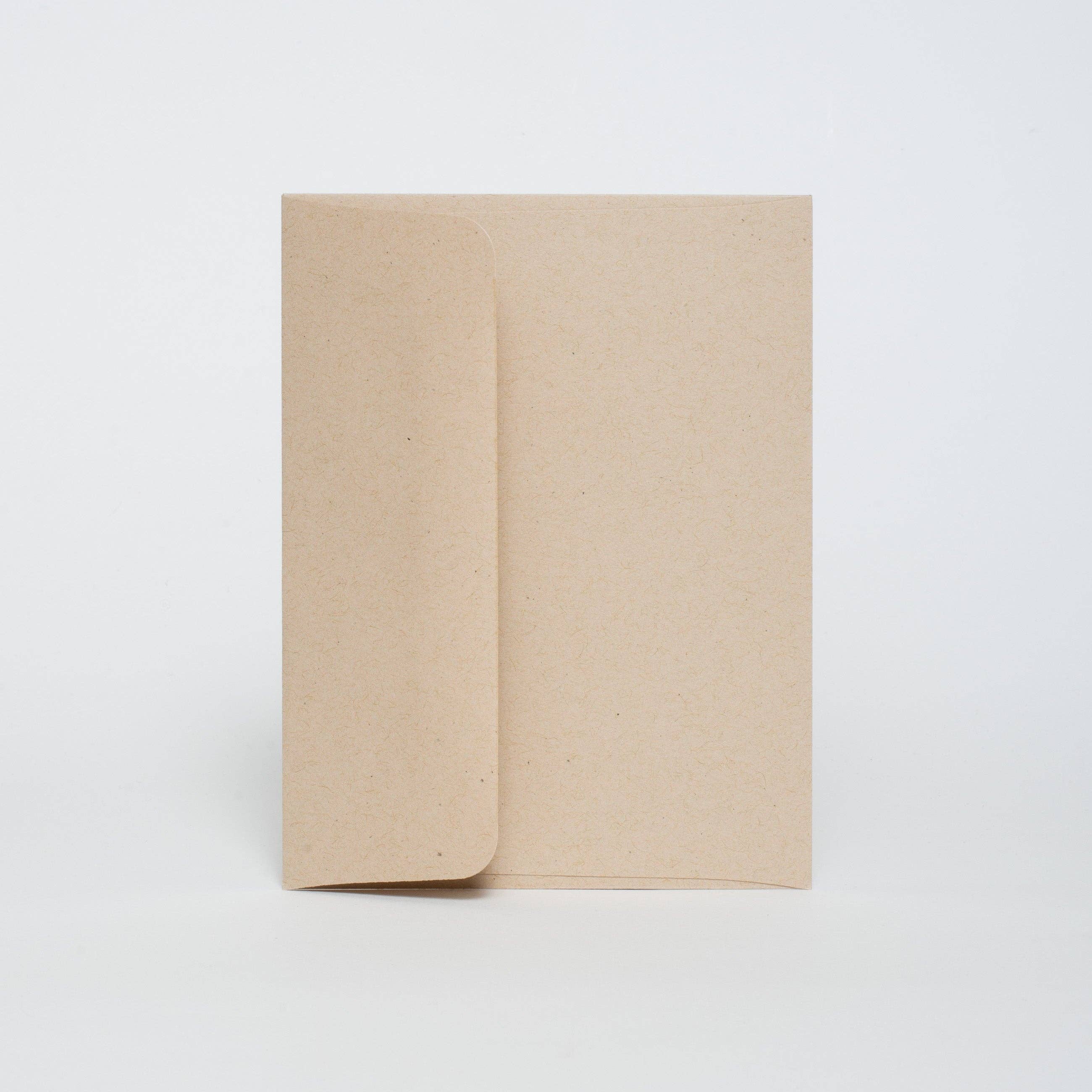 Two beige notebooks stacked on a white background