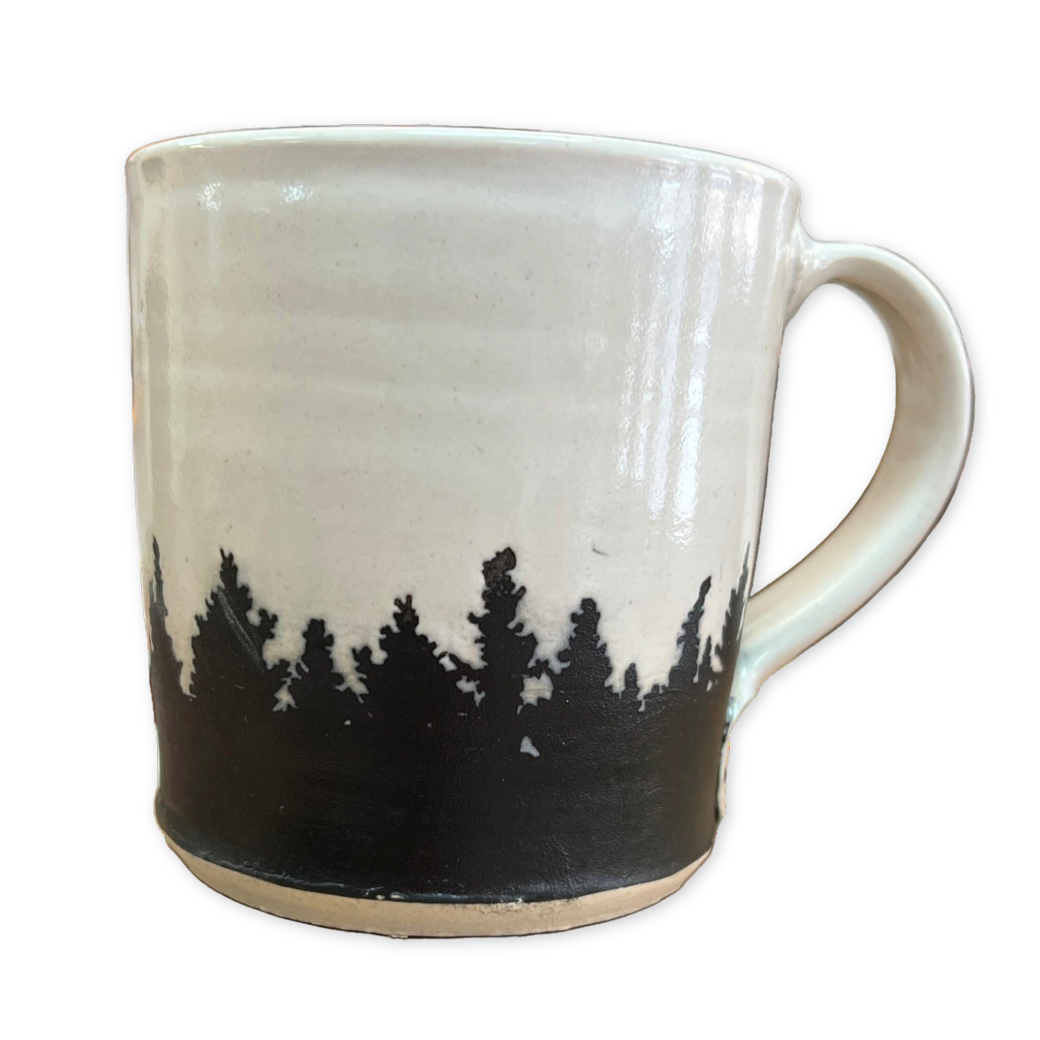 white ceramic mug with a black pine tree forest design