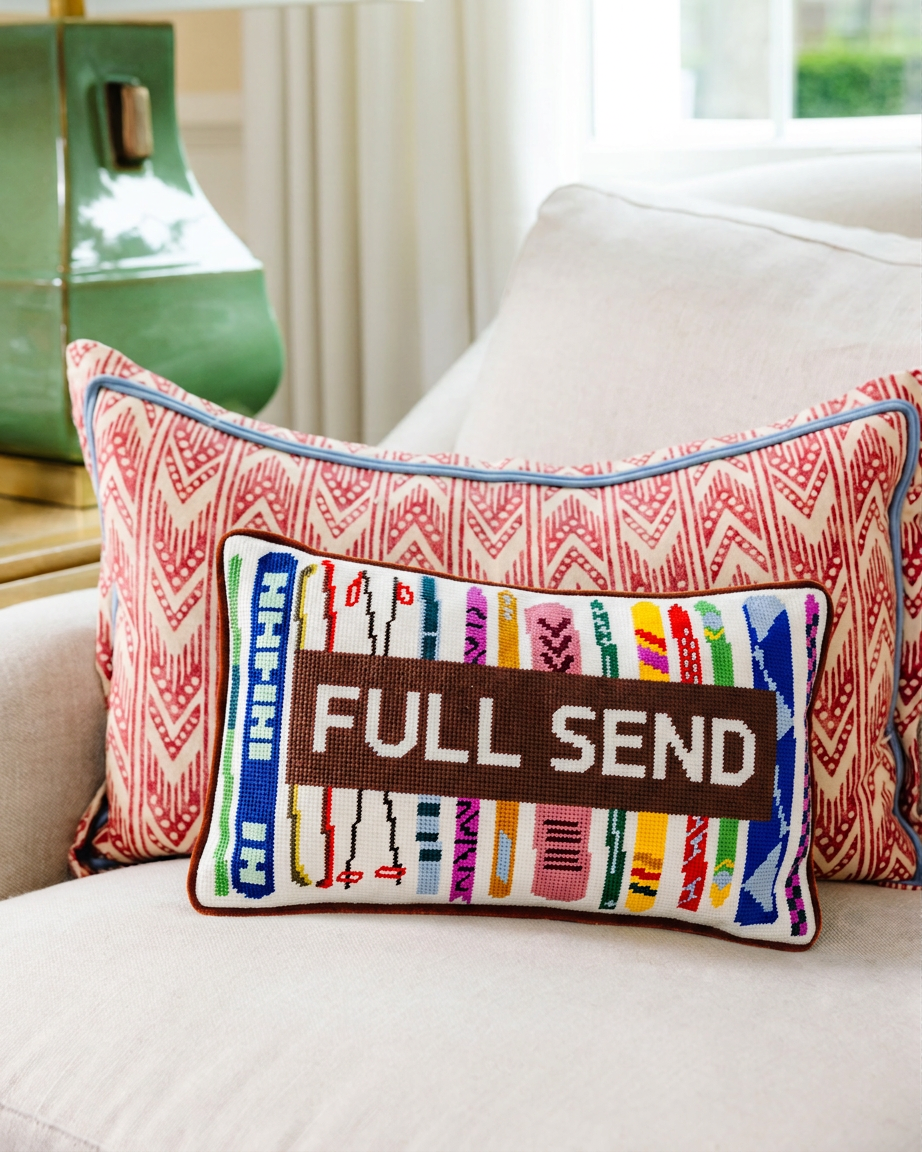 Decorative pillow with 'FULL SEND' Embroidered on it.