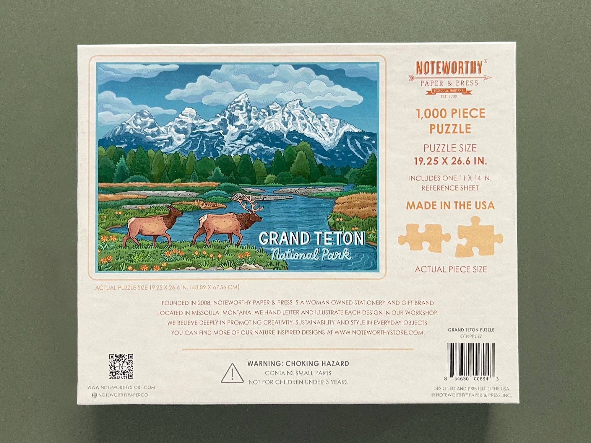 Noteworthy puzzle packaging with Grand Teton National Park illustration on a green background