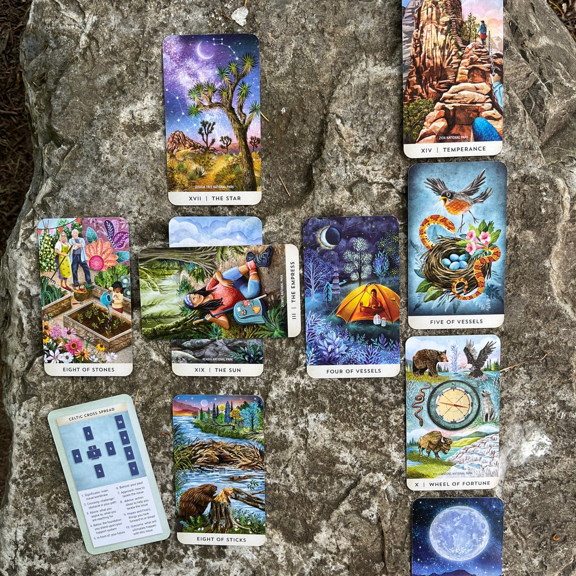 Collection of tarot cards displayed on a stone surface