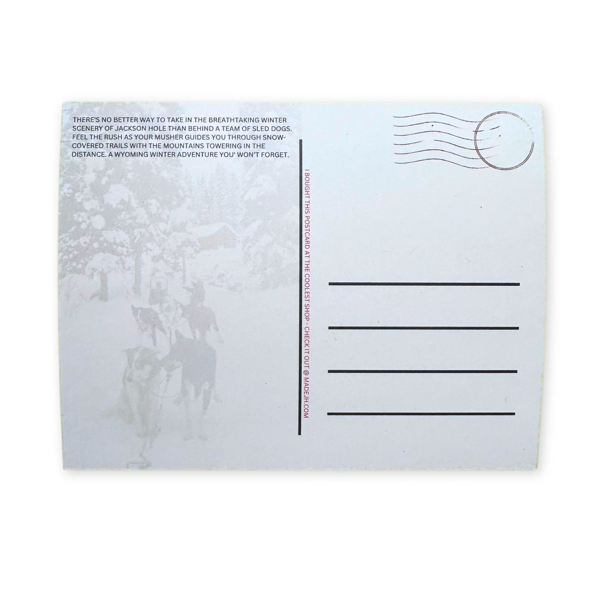 Postcard with a snowy landscape and dogs, featuring text and a stamp.