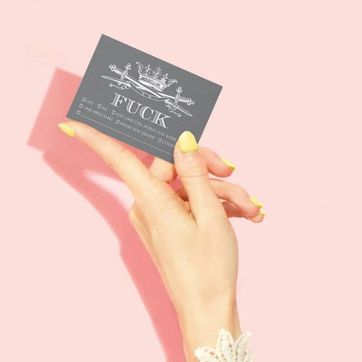 Hand holding a card with text on a pink background