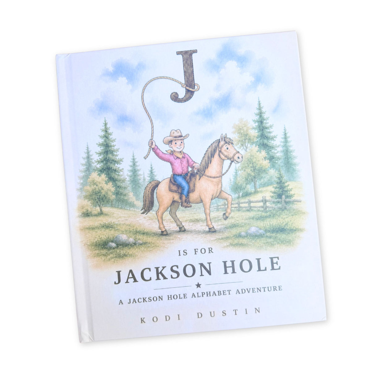 A children's book titled 'Is for Jackson Hole: A Jackson Hole Alphabet Adventure' by Kodi Dustin, featuring a western-themed illustration of a cowboy on a horse with a large letter 'J' in the sky, shown on a clean white background.