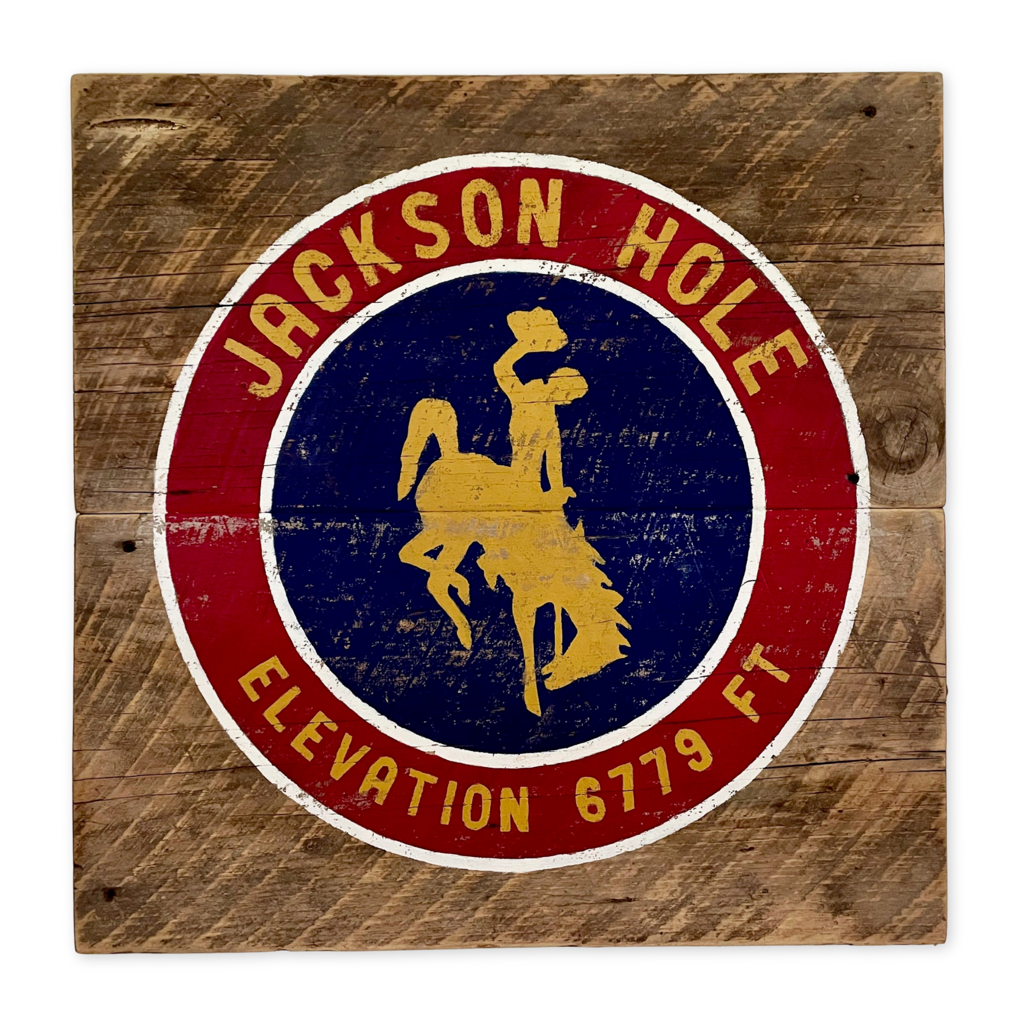 wooden sign with an image of the wyoming bucking bronco and jackson hole printed on it