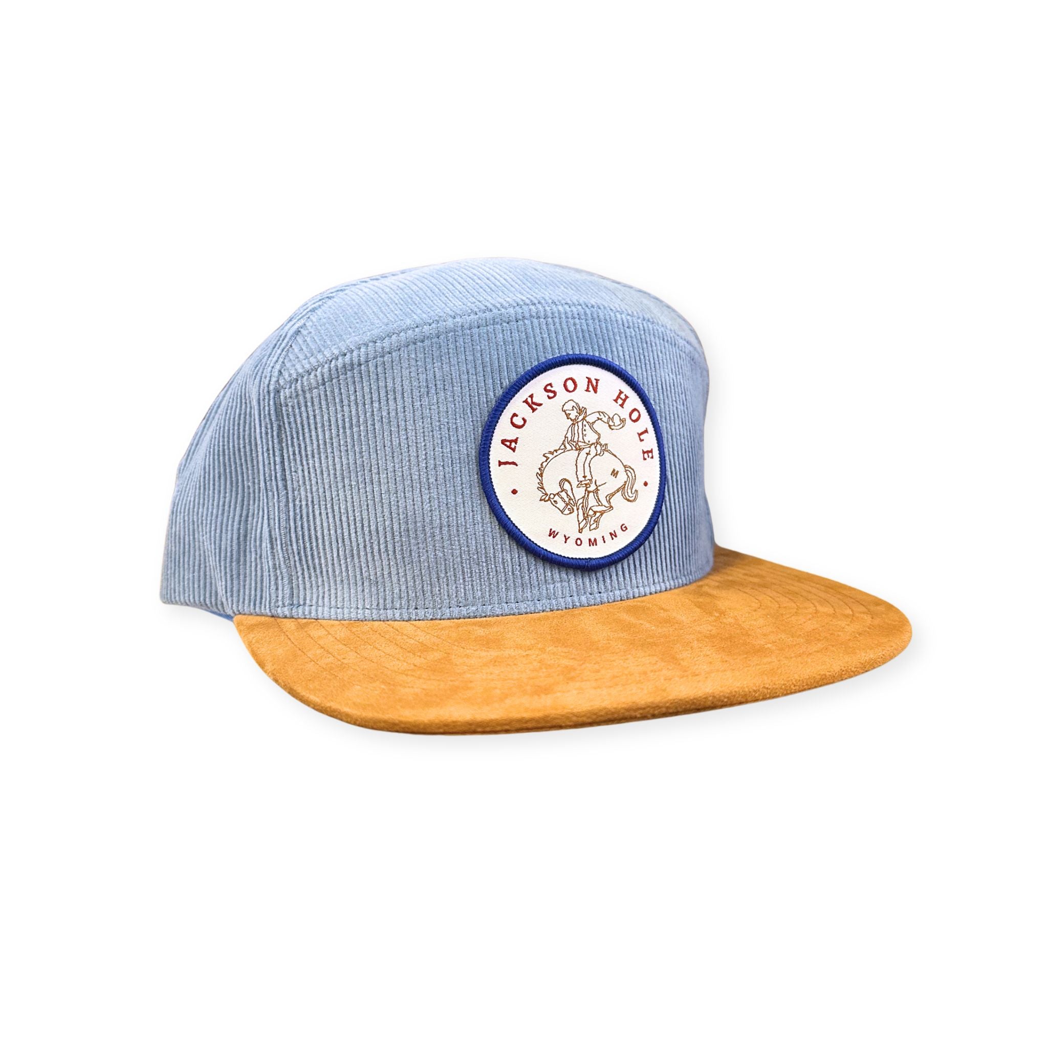 A two tone corduroy hat, colors are blue and tan. Features the circular Jackson Hole Bronco patch. Colors are Red, White, and blue. 