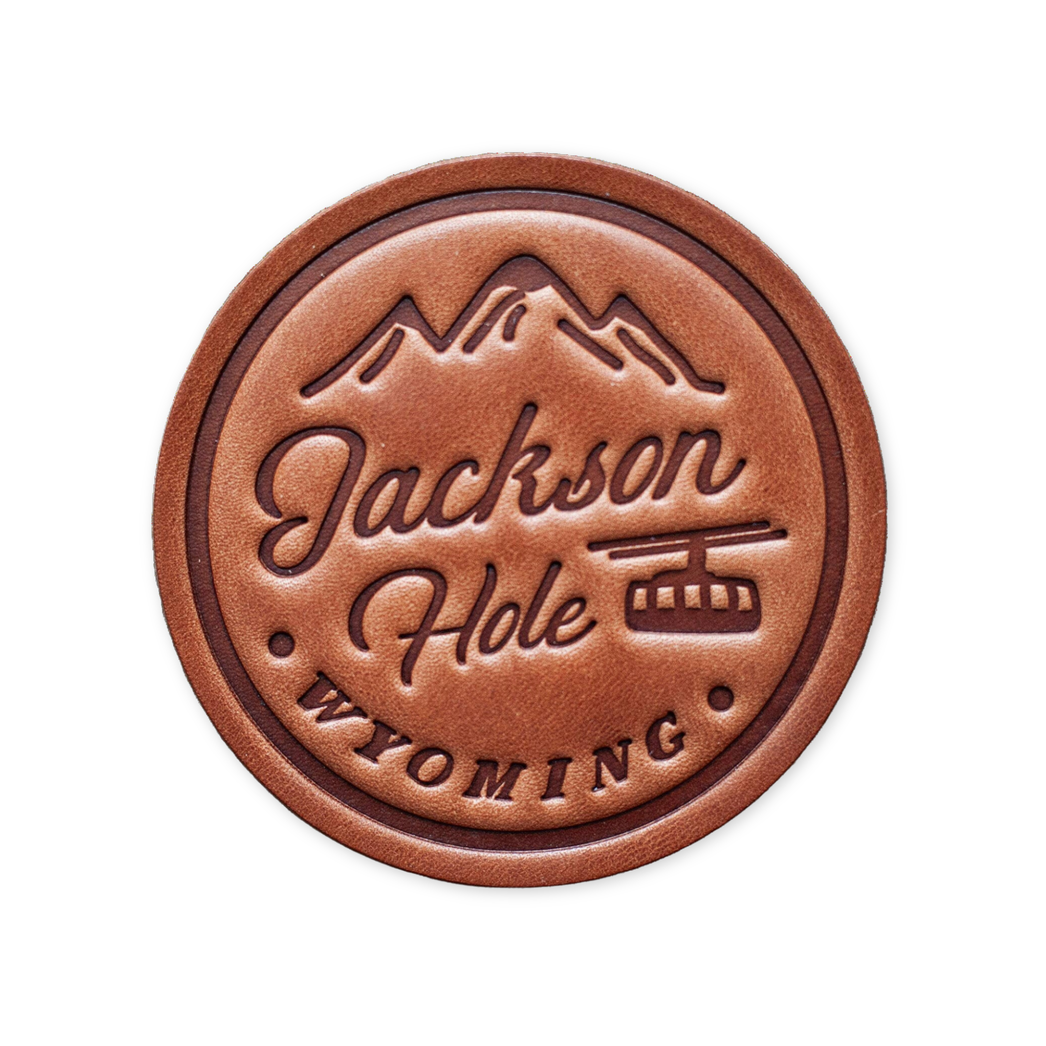 hand cut leather coaster with the words jackson hole wyoming