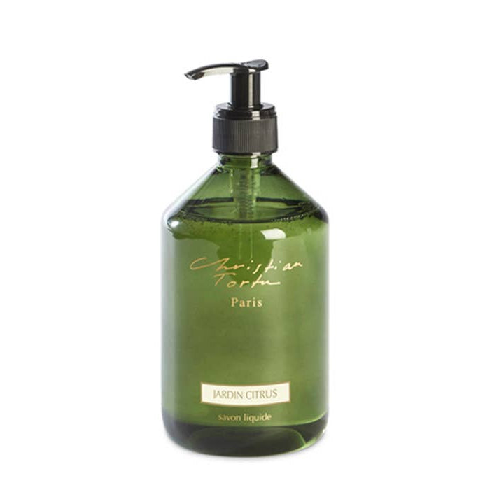 Green bottle with pump labeled 'Christian Torta' on a white background