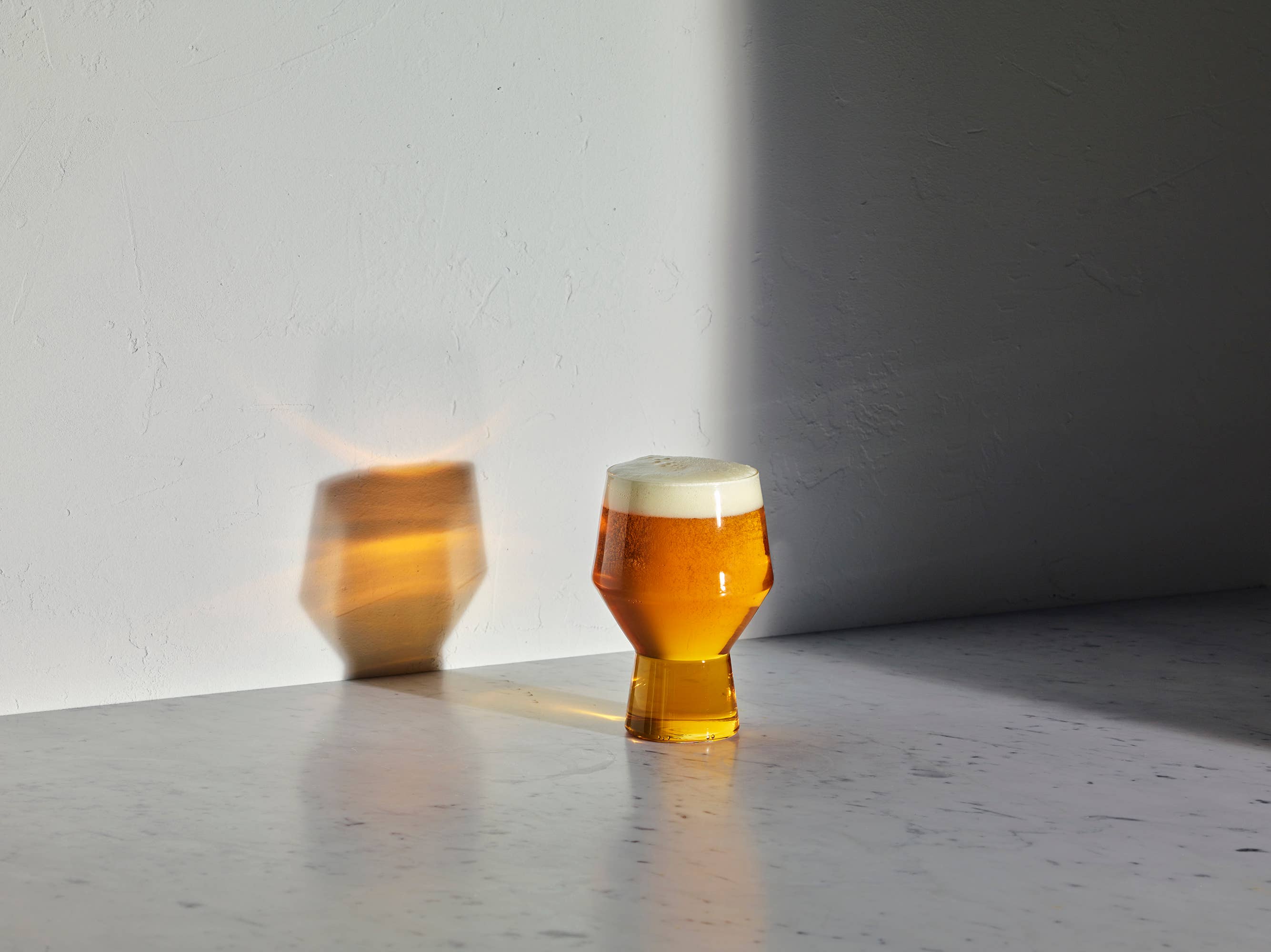 Two glasses of beer with a white background