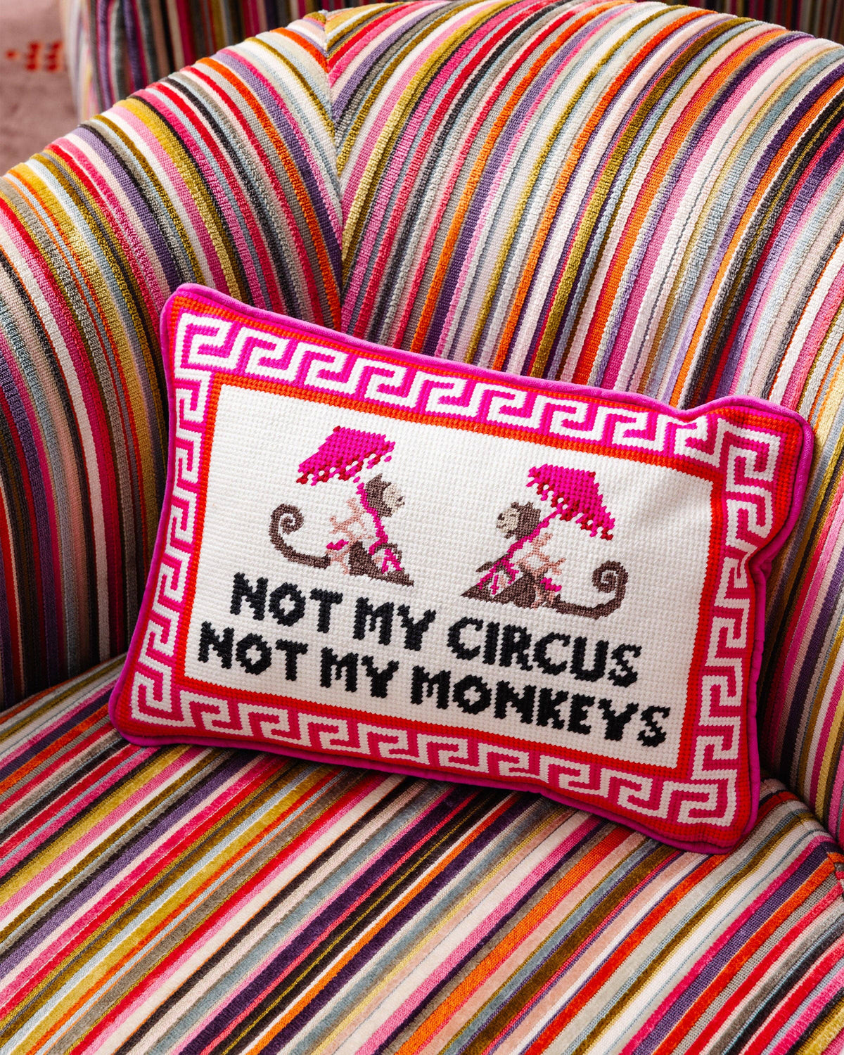 Embroidered pillow with 'Not my circus, not my monkeys'.
