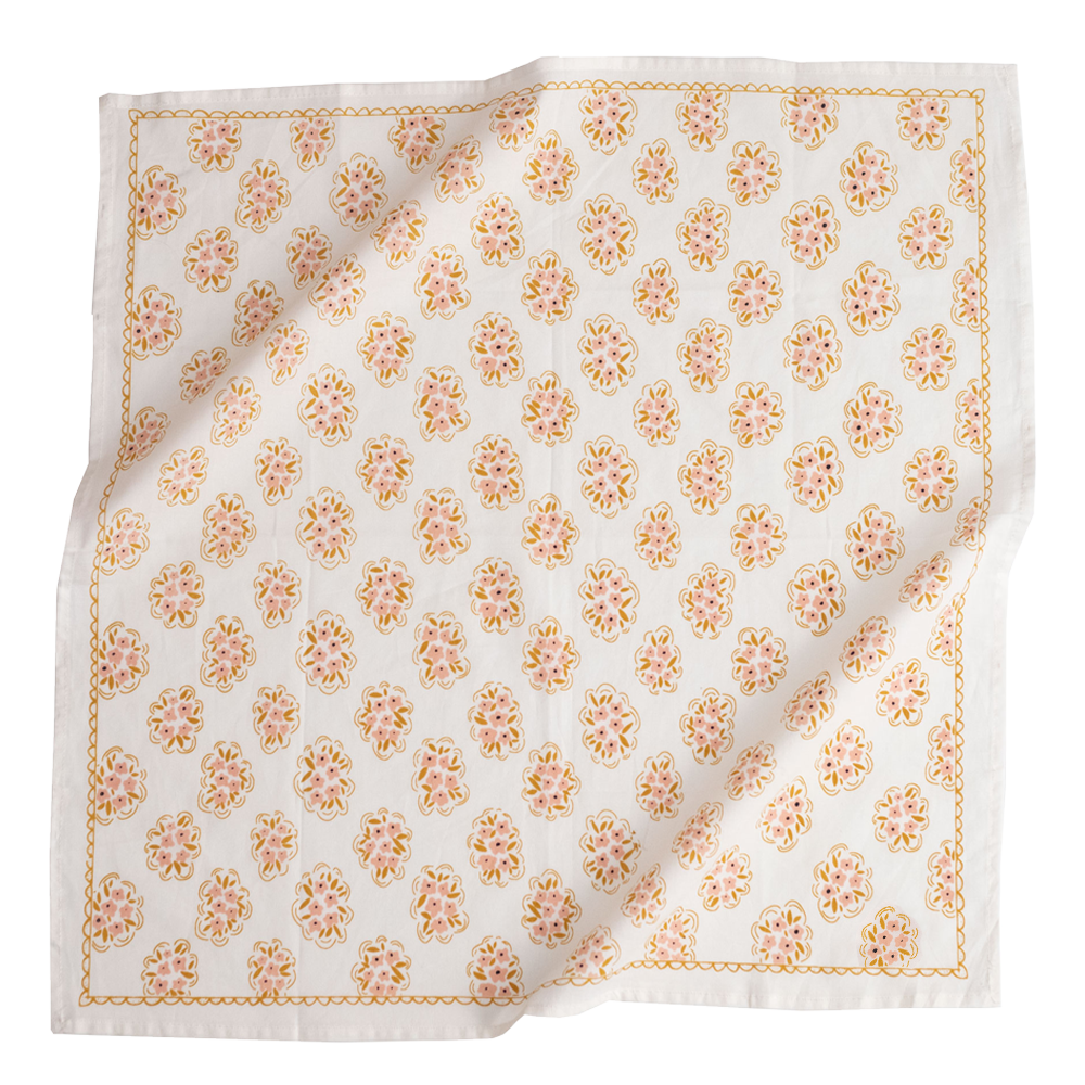 A cream-colored bandana with a pattern of pink and gold flowers