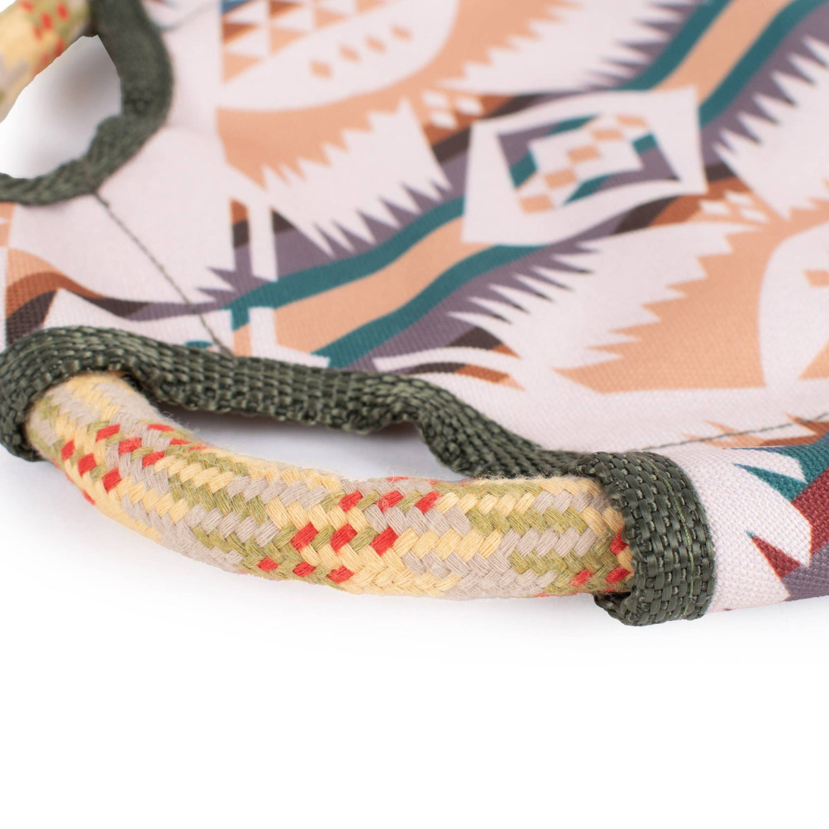Close-up of a dog toy with a braided handle and pendleton fabric.