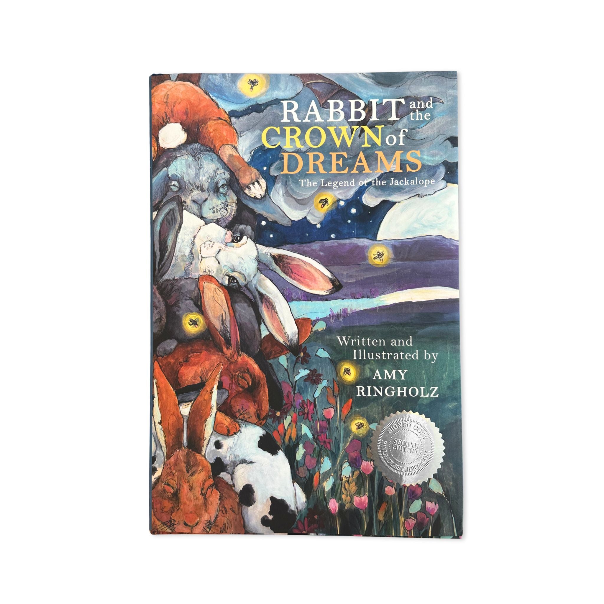 Book cover of 'Rabbit and the Crown of Dreams' with illustrations of rabbits and a night sky.