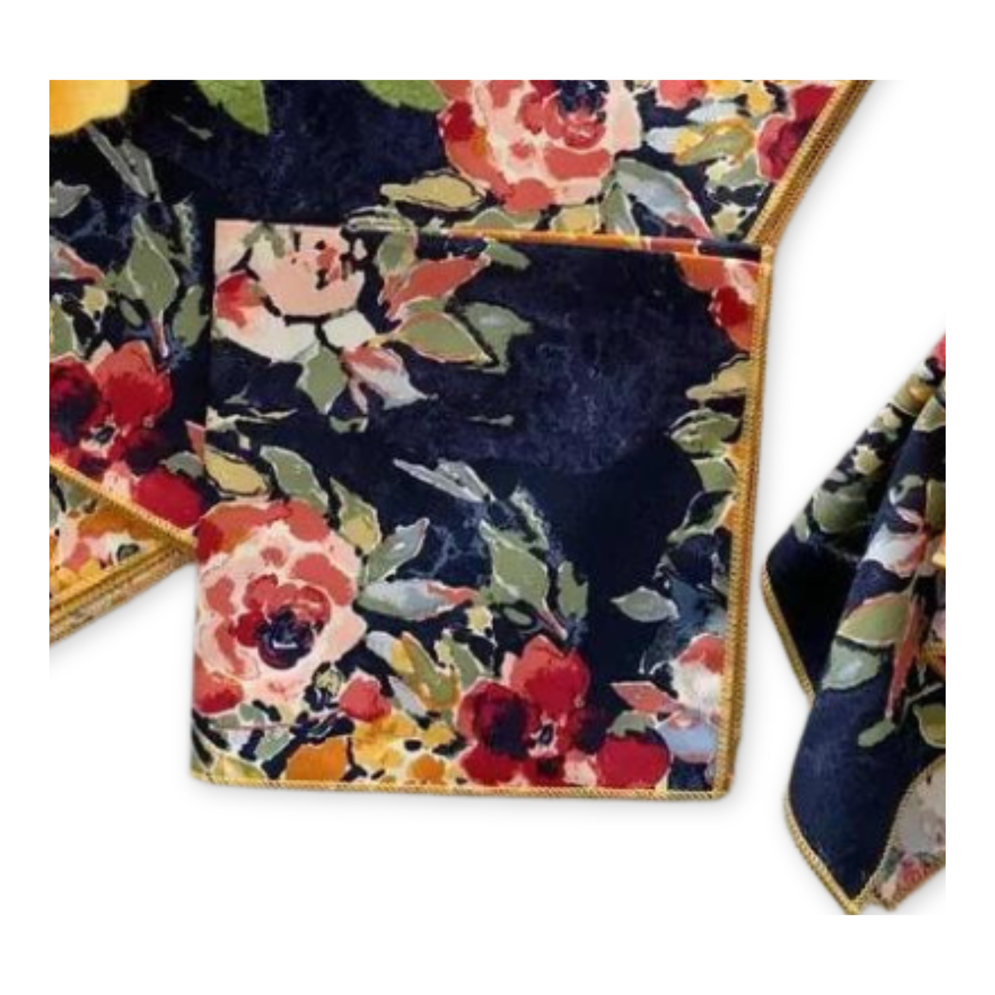 set of four cotton cloth cocktail napkins with bright floral pattern popping on a dark blue background and a yellow hem