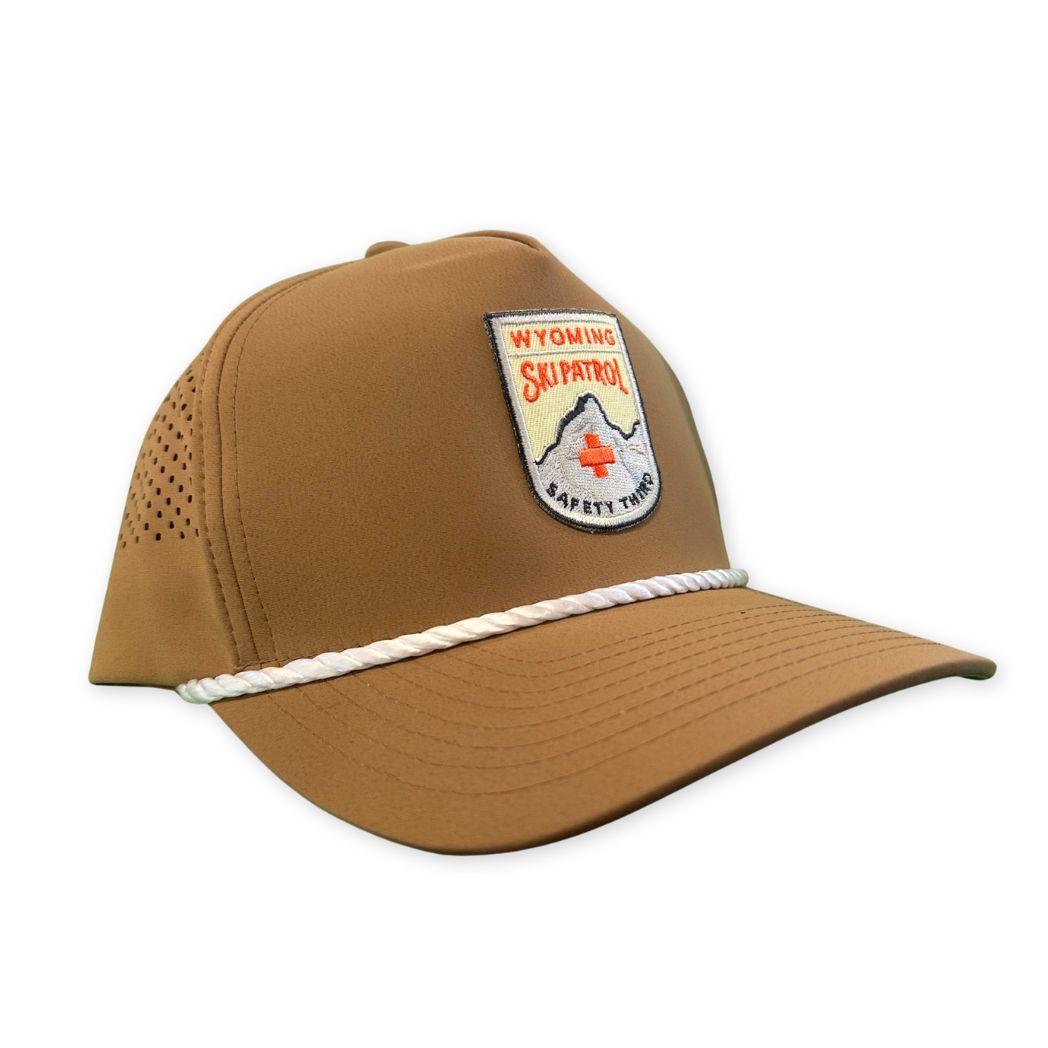 Brown cap with Wyoming Ski Patrol patch on a white background