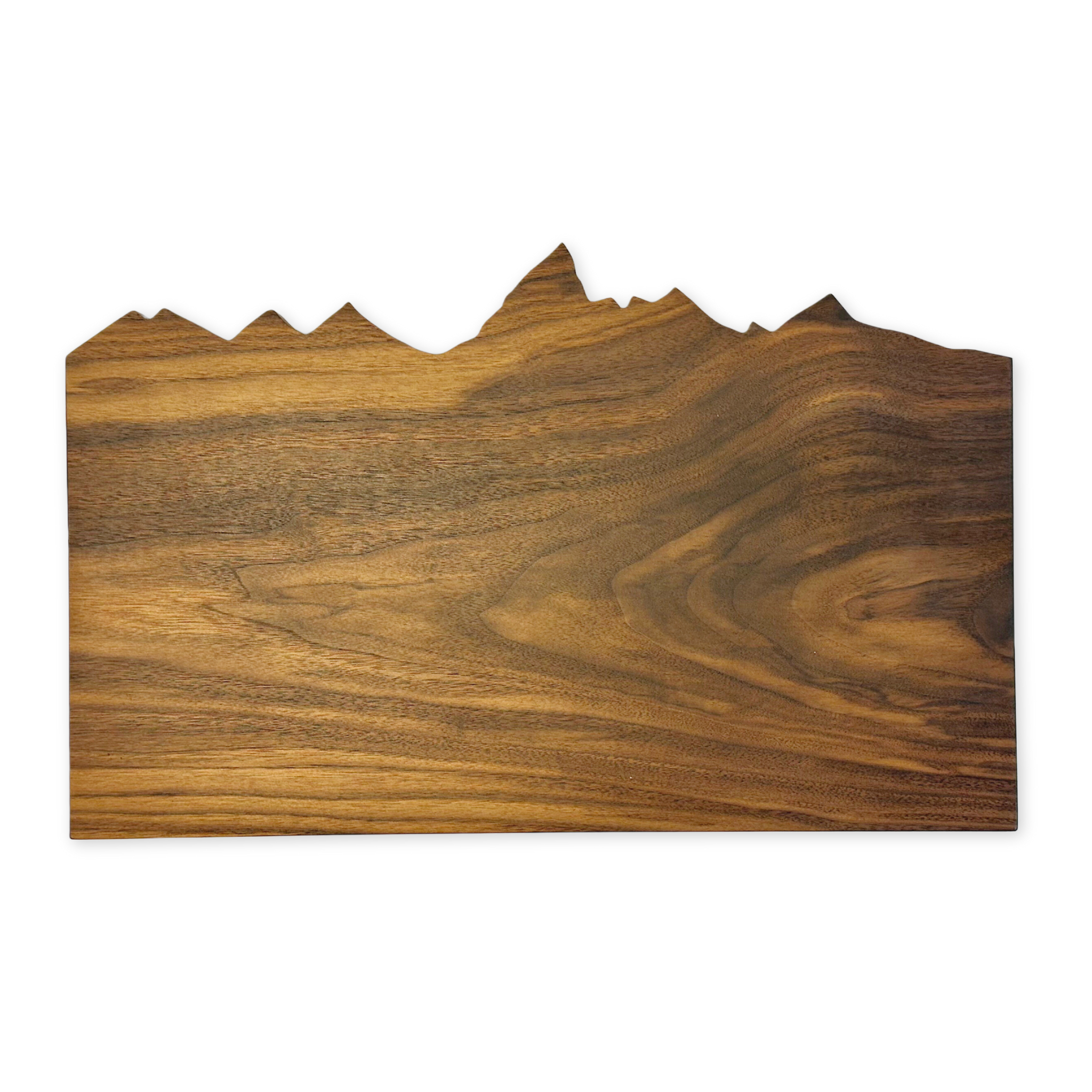 handcrafted cutting board with the top edge cut out in the shape of the teton range 