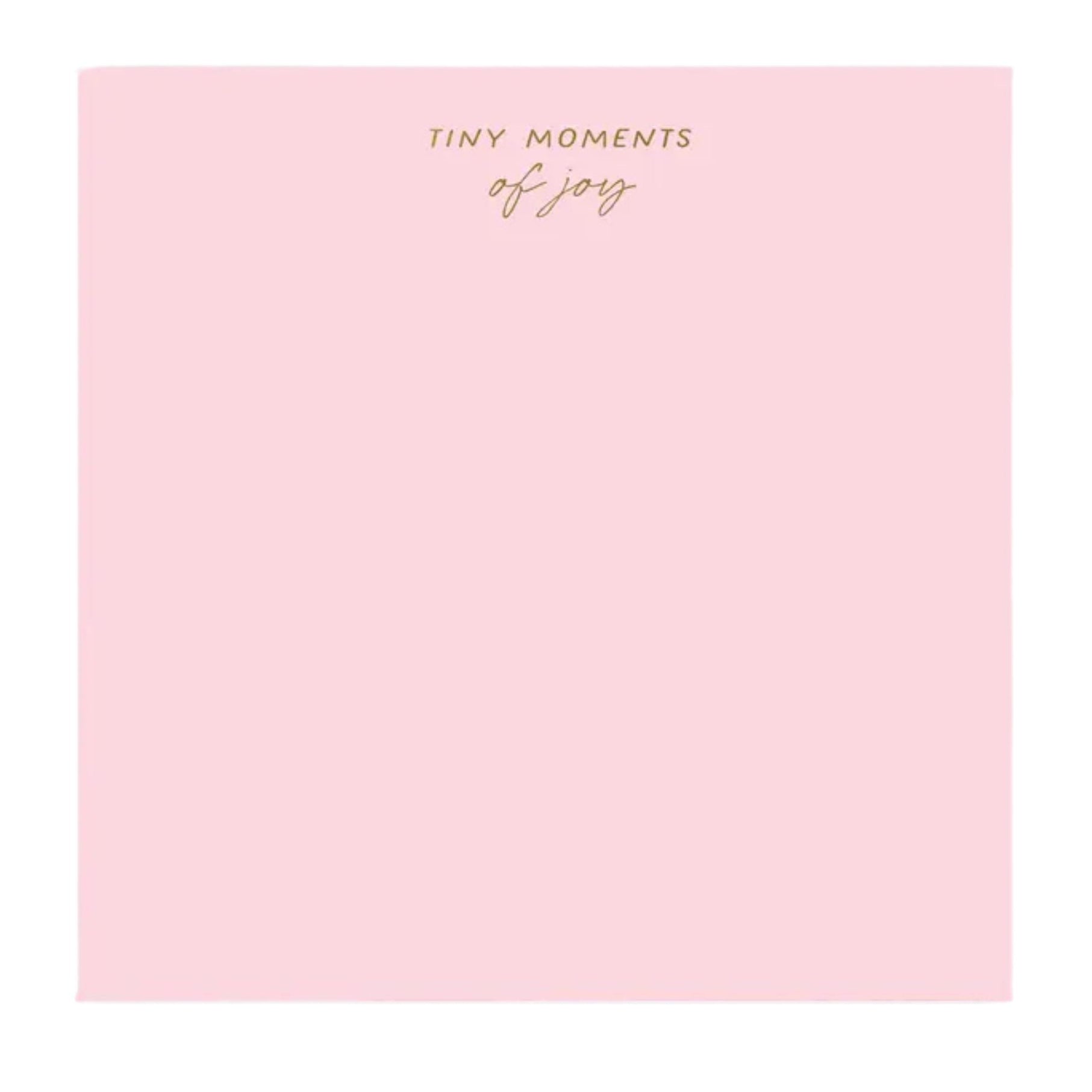 Pink notebook with 'Tiny Moments of Joy' text on a white background