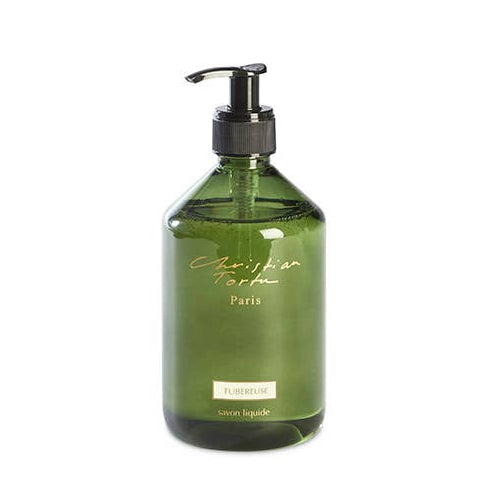 Green bottle with pump dispenser on a white background