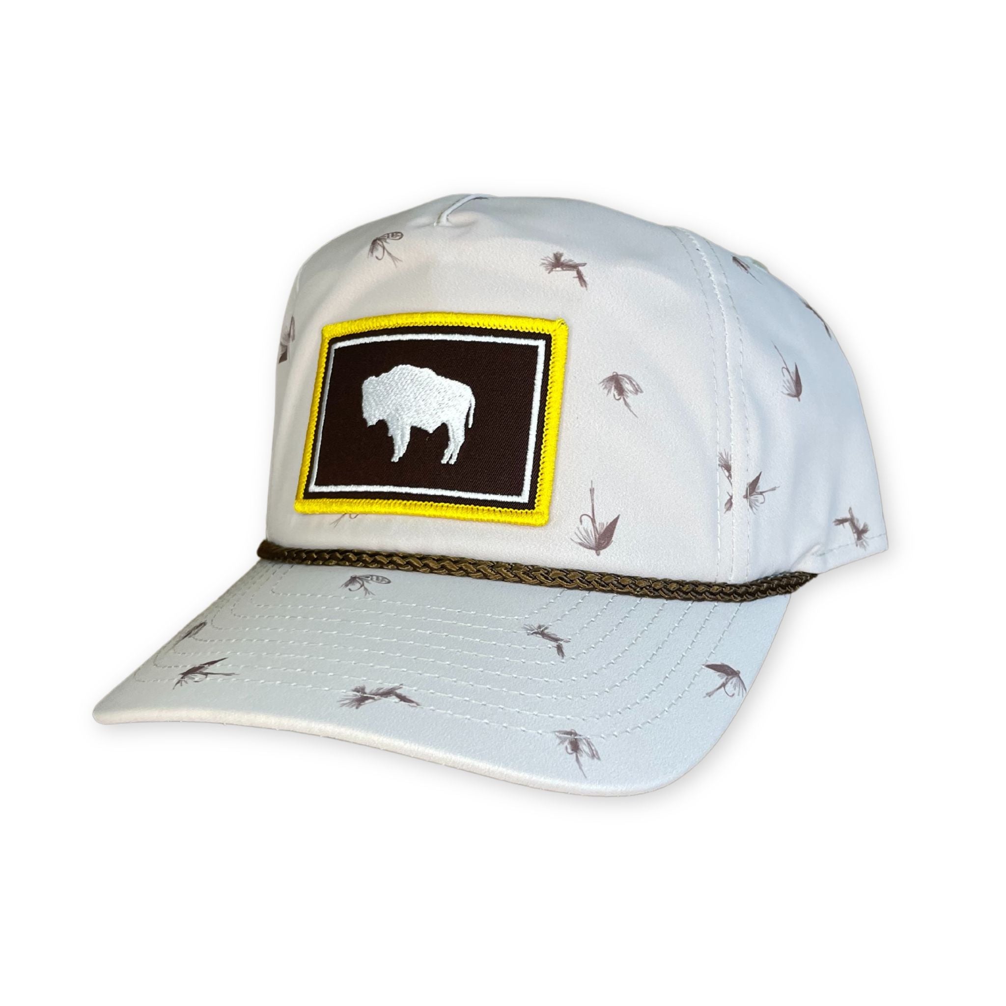 White hat with Wyoming flag patch on front. pattern of fishing lures on whole hat. 