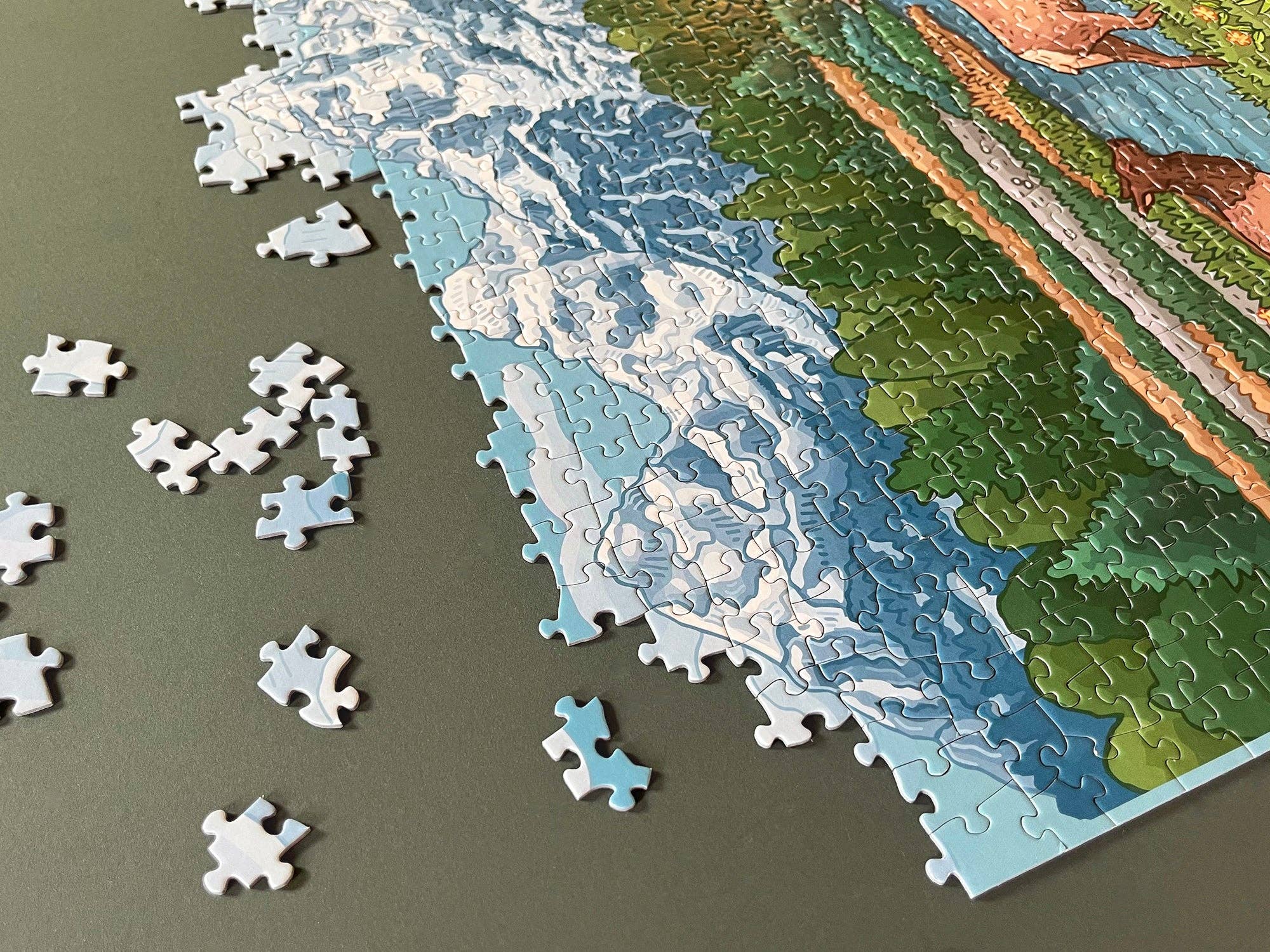 Partial puzzle with a landscape design on a gray surface
