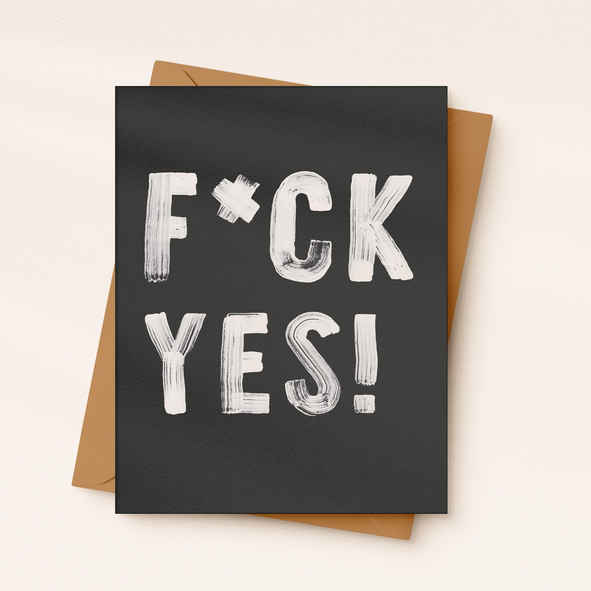 Greeting card with 'F*CK YES!' text on a black background with a brown envelope.