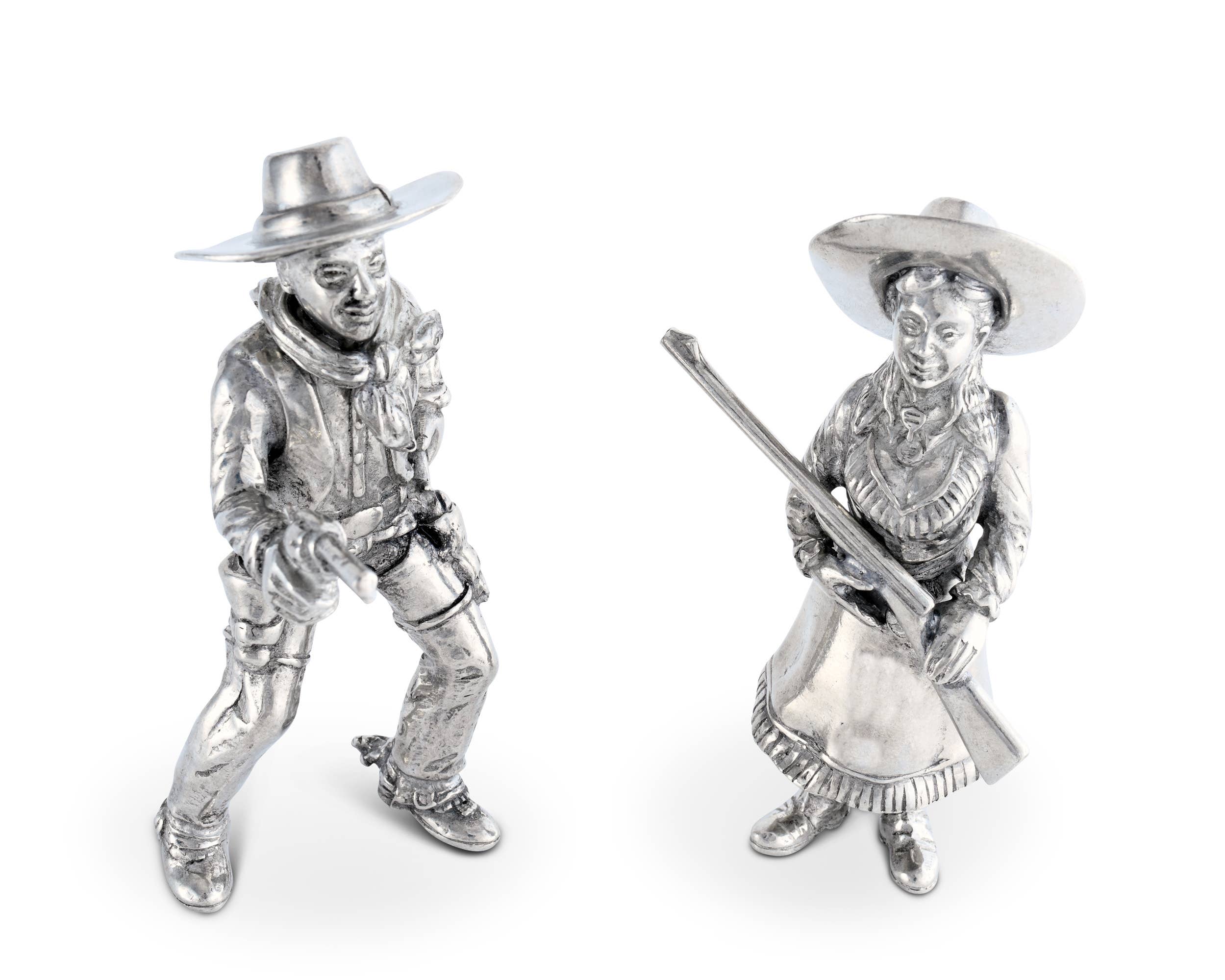 Two silver cowboy figurines on a white background