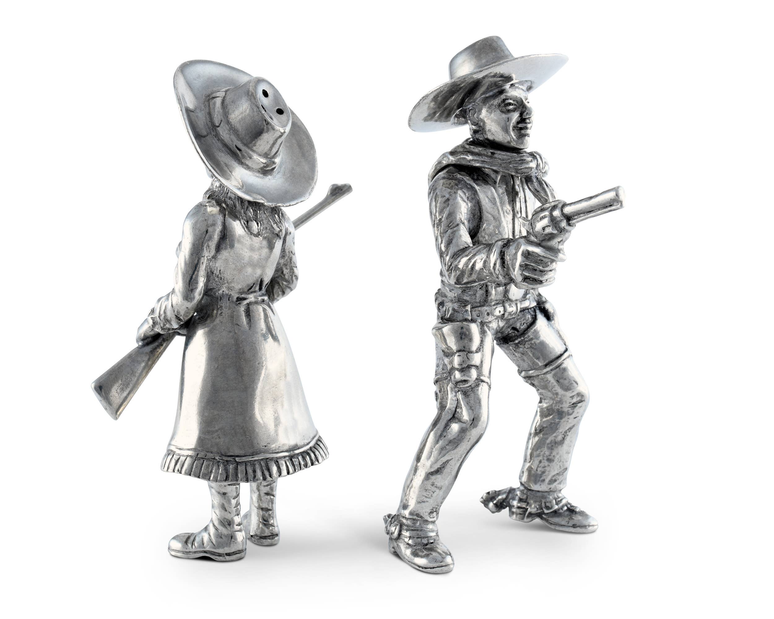 Two silver cowboy figurines on a white background